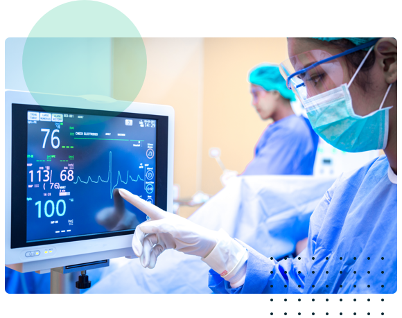 Nurse in mask/gown looking at heart monitor on screen - HealthStream
