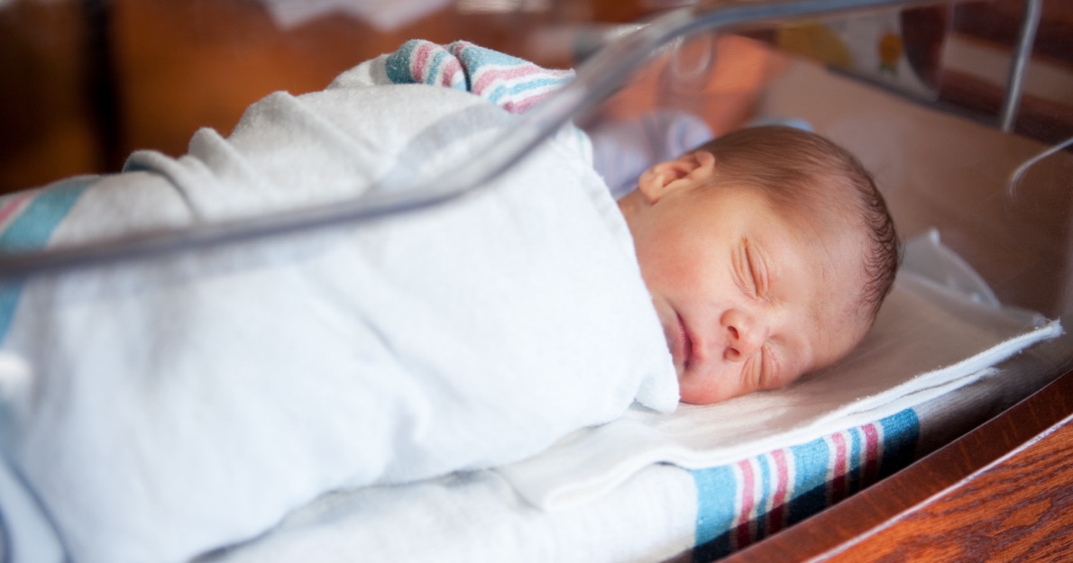 Infant swaddled in blanket in hospital - HealthStream